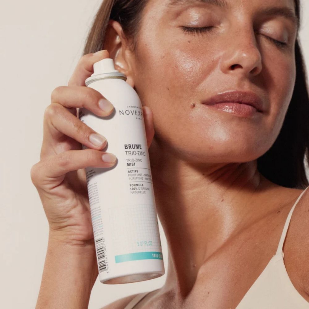 Femme qui utilise la brume trio-zinc novexpert