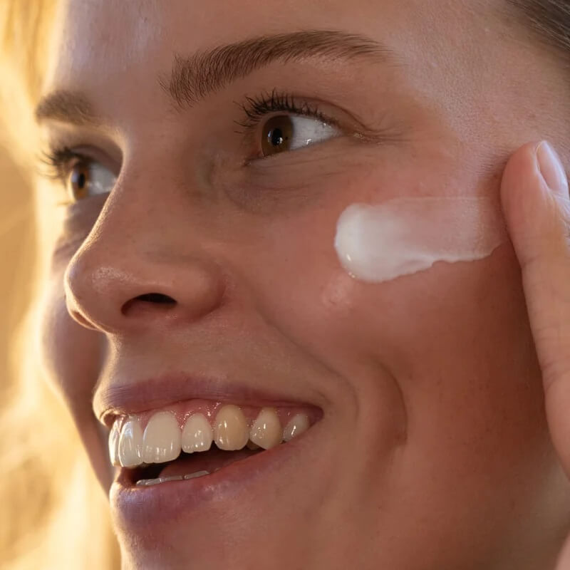 creme concentree appliquee sur la joue d'une femme