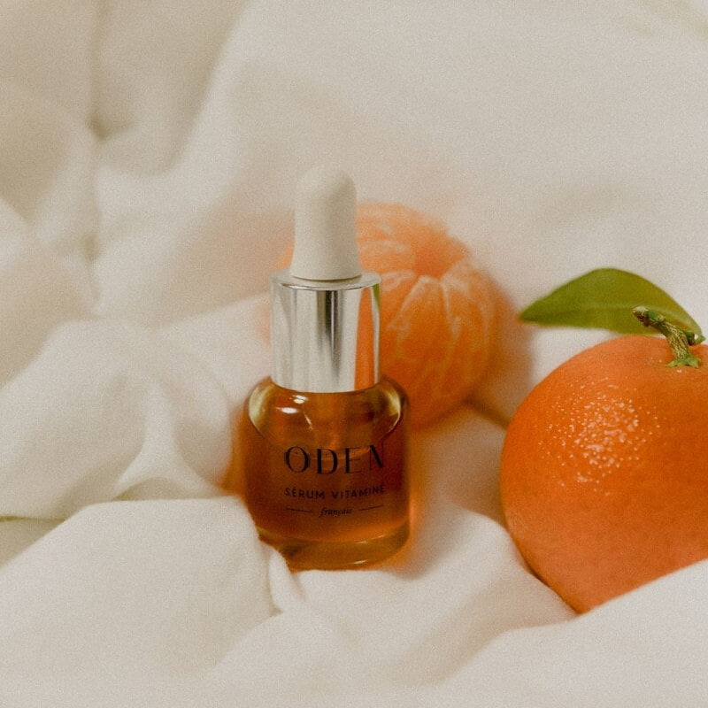 serum vitamine oden devan des clementines sur une drap blanc