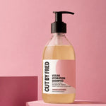 visuel sur fond rose du shampoing hydratant cut by Fred